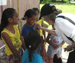 Deputy Director Jody K. Olsen talks with Mokil Island girls.  Peace Corps Volunteer Zack Stepan teaches English in the only island school.