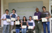 Interns holding certificates after awards ceremony