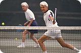 A man and woman playing tennis.