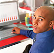 A man with his hand on a keyboard of a computer.