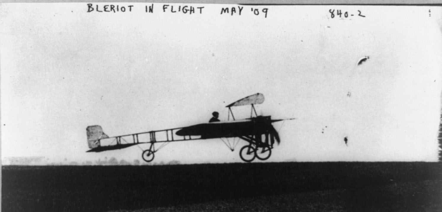 The flying wires can be seen in this photo of Blériot in flight in May 1909.

