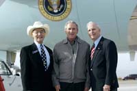 President George W. Bush met Bob Carlone and Joe Henjum upon arrival in Colorado Springs, Colorado, on Tuesday, October 12, 2004.  Carlone, 75, and Henjum, 70, founded The Home Front Cares program to provide support for military families in the Pikes Peak region whose loved ones are deployed.  