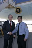 President George W. Bush presented the President’s Volunteer Service Award to Al Agellon upon arrival at Davis-Monthan Air Force Base, Arizona, on Monday, November 28, 2005.  Agellon is a volunteer with the Tucson Police Department’s Police Assist Group (PAG).   To thank them for making a difference in the lives of others, President Bush has met with over 450 individuals around the country, like Agellon, since March 2002.