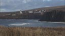 Looking across a Bering Sea cove to St. George village, which sits in the distance above cliffs.