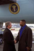 President George W. Bush met Garry Cobb upon arrival in Philadelphia, Pennsylvania, on Thursday, December 12, 2002. Cobb, a former Philadelphia Eagles football player, volunteers as a mentor for disadvantaged children. 