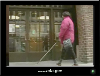 photo of a woman using a white cane