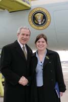 President George W. Bush presented the President’s Volunteer Service Award to Anna Edlund upon arrival at the airport in Minneapolis, Minnesota, on Thursday, February 2, 2006.  Edlund is the founder of Funky Minds, a community outreach program in Carver, Minnesota.  To thank them for making a difference in the lives of others, President Bush has met with more than 460 individuals around the country, like Edlund, since March 2002.