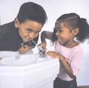 Image of a boy and a girl at a water fountain.