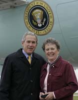 President George W. Bush presented the President’s Volunteer Service Award to Sally Bates upon arrival at the airport in Des Moines, Iowa, on Thursday, October 26, 2006.  Bates, a two time breast cancer survivor, is a volunteer with the Des Moines Affiliate of the Susan G Komen Breast Cancer Foundation.  To thank them for making a difference in the lives of others, President Bush honors a local volunteer, called a USA Freedom Corps Greeter, when he travels throughout the United States.  President Bush has met with more than 500 individuals around the country, like Bates, since March 2002.