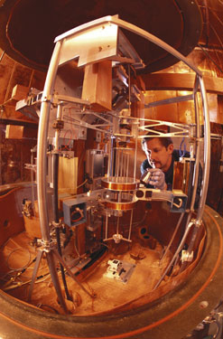 Scientist load kilogram mass into the NIST watt balance apparatus