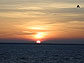 A picture of the setting sun off the coast of Estonia and the letter "A."