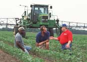 Louisiana farmer in no-till field with NRCS employees