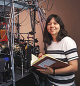 Researcher holding lab book, next to laboratory equipment-Copyright Geoffrey Wheeler