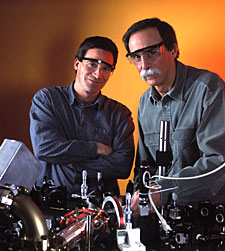 NIST physicists Dietrich Leibfried and David Wineland in the laboratory where they have developed a method for correcting data handling errors for quantum computing. ©Geoffrey Wheeler