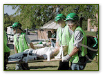 CERT volunteers carrying an injured person on a stretcher.
