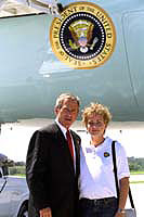 President George W. Bush met Erika McCroskey upon arrival in Des Moines. McCroskey is a 24 year-old AmeriCorps member from Monroe, Iowa, who began volunteering as a child and is now preparing for a new service experience in Bolivia. 