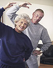 An older couple doing aerobics.