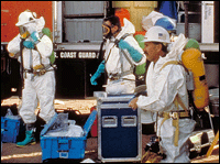Emergency responders suit up in protective gear to respond to a chemical spill.