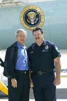 President George W. Bush met Bryan Comstock upon arrival in Minneapolis, Minnesota, on Wednesday, August 4, 2004.  Comstock is a volunteer firefighter with the Mankato Fire Department.
