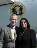 President George W. Bush presented the President’s Volunteer Service Award to Michelle Gilmore upon arrival at the airport in Greensboro, North Carolina, on Wednesday, October 18, 2006.  Gilmore is a volunteer with a variety of community organizations through Team Bank of America, the volunteer network of her employer, Bank of America B.A.  To thank them for making a difference in the lives of others, President Bush honors a local volunteer, called a USA Freedom Corps Greeter, when he travels throughout the United States.  President Bush has met with more than 500 individuals around the country, like Gilmore, since March 2002.