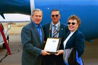 President George W. Bush presents Franklin and Carol-Ann Heller with the President's Volunteer Service Award in Wells, Maine, on Thursday, April 22, 2004. The Hellers are active volunteers with the Wells National Estuarine Research Reserve.