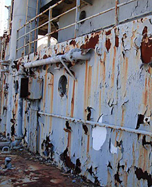 Photo of mothballed ships with peeling paint.