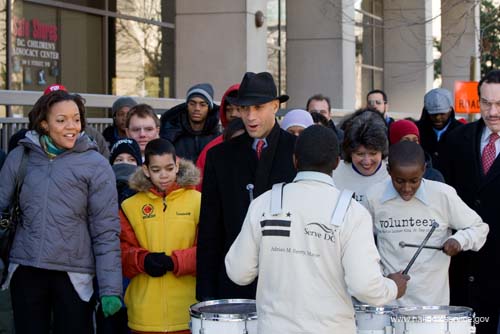 Millicent Williams, executive director of Serve DC, Washington, D.C. Mayor Adrian Fenty, and Councilwoman Carol Schwartz, left to right, participate in the march to the Community for Creative Nonviolence as young musicians perform. About 20,000 people in the District of Columbia participated in nearly 150 service projects in honor of the slain civil rights leader on January 21, 2008.