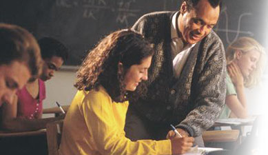 photograph of a teacher helping an adult student in a classroom