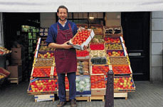 A grocer displaying vegetables.