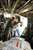 U.S. military personnel load supplies onto a helicopter.