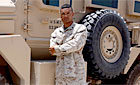 Photo - U.S. Marine Corps Cpl. Miarco T. McMillian is a certification instructor for the new Joint Explosive Ordnance Disposal Rapid Response Vehicle, or JERRV, with Regimental Combat Team 6. The JERRV, pictured behind McMillian, is the newest addition to the Corps' arsenal to combat the threat from roadside bombs. U.S. Marine Corps photo by Sgt. Stephen M. DeBoard
