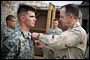 U.S. Navy Adm. Mike Mullen, chairman of the Joint Chiefs of Staff, awards the Silver Star to U.S. Army Capt. Gregory Ambrosia in Korengal Outpost, Afghanistan, July 11, 2008.