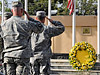 Servicemembers of Combined Security Transition Command Afghanistan salute the colors at a remembrance ceremony at Camp Eggers in Kabul, Afghanistan, Sept. 11, 2008. U.S. Navy photo by Seaman Tim Newborn, Combined Security Transition Command Afghanistan