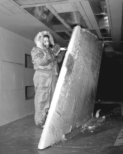 Technician measures ice deposits on an airfoil
