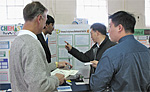 NRC's Doug Coe, Hosung Ahn and Richard Chang talk to a student at the annual Montgomery County Science Fair