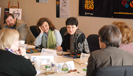 meeting attendees interacting around a conference table