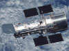 hubble telescope with clouds below
