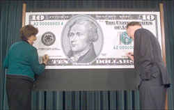 U.S. Treasurer Rosario Marin and Treasury Secretary John W. Snow provided their signatures on a display ten dollar bill.