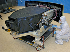 Image of a man in a bunny suit working on the WFC3 enclosure in the clean room at Goddard.