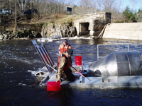 Researchers removing very young salmon bound for the Atlantic from water-powered traps in the Sheepscot River.