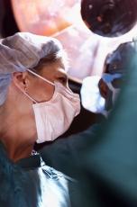 Photograph of a female nurse assisting in surgery