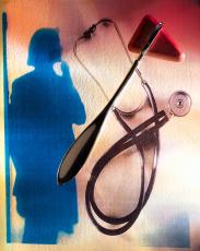 Photograph of a stethoscope and a reflex tester with a woman's shadow in the background