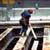 Worker standing on unprotected sides of floor holes