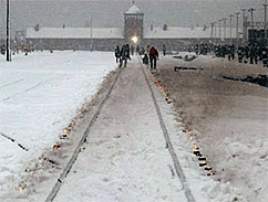 Candles mark the railway tracks leading to the Auschwitz camp during the commemoration of the 60th anniversary of the liberation of the camp. Poland, January 27, 2005.