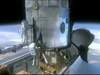 image from animation of astronauts working on Hubble while it is docked in the shuttle