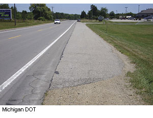 A full-width approach shoulder in advance of a commercial driveway, as required by a Michigan DOT field office, provides the older driver with the same pressure-free turning movement as is provided by a right-turn lane. Michigan DOT