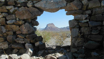 Cerro Castellan seen through a hole in a stone wall