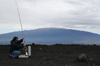 NOAA engineer Paul Fukumura-Sawada captures air near NOAA’s Mauna Loa Observatory in Hawaii.