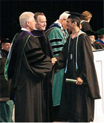 Former presidents Bill Clinton and George H. W. Bush congratulate Shirin Kazimov for his master’s degree at Tulane University’s 2006 graduation ceremony.