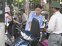 A gas station attendant fills up a motorbikes tank at a station in Hanoi on